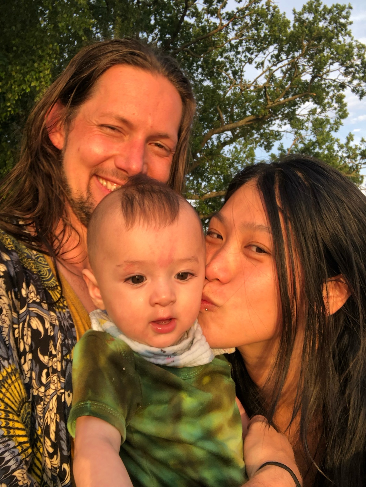 Guy, Tian and baby Cosmo in golden hour light