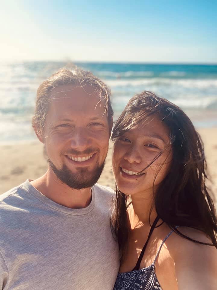 Guy and Tian smiling at the beach